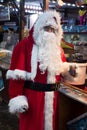 portrait of man wearing a santa claus costume at the mulled wine cabin at the christmas