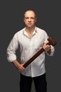 Portrait of a man in a white shirt with a hammer Royalty Free Stock Photo