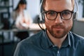 Portrait of man. Woman is on background. Two employees are working together in the modern office Royalty Free Stock Photo