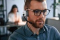 Portrait of man. Woman is on background. Two employees are working together in the modern office Royalty Free Stock Photo