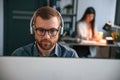 Portrait of man. Woman is on background. Two employees are working together in the modern office Royalty Free Stock Photo