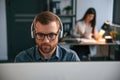 Portrait of man. Woman is on background. Two employees are working together in the modern office Royalty Free Stock Photo