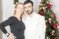 Portrait of a man and woman near the Christmas tree.