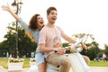 Portrait of man and woman riding on motorbike together through city street Royalty Free Stock Photo