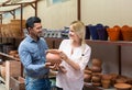 Portrait of man and woman shopping ceramic utensil in boutique Royalty Free Stock Photo