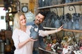 Portrait of man and woman shopping ceramic utensil in boutique
