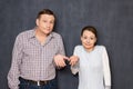 Portrait of man and woman shrugging shoulders and silly smiling Royalty Free Stock Photo