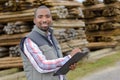 Portrait man in woodyard with clipboard Royalty Free Stock Photo