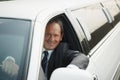 Portrait Of Man Working As Driver In White Limousine Royalty Free Stock Photo