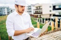 Portrait of man working on construction site. Engineer, worker and architect concept