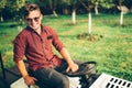 Portrait of man working on ride-on lawn mower tractor