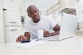 Portrait of a man working and using his laptop and looking at camera Royalty Free Stock Photo