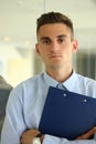 Portrait of manager businessman holding photo of vertical clipboard