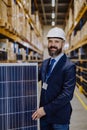 Portrait of manager holding a solar panel in a warehouse. Royalty Free Stock Photo