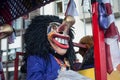 Portrait of masked person parading in the street throwing confetti