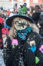 portrait of masked witch parading in the street