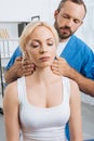 portrait of massage therapist massaging neck of young woman Royalty Free Stock Photo