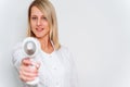 Portrait of master of laser hair removal. Woman in white coat hold laser hair removal device in her hands and show as