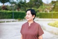 Portrait of mature asian woman standing at public park,Happy and smiling,Senior care insurance concept