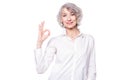 Portrait of a mature attractive woman wearing elegant shirt standing over isolated white background smiling with happy Royalty Free Stock Photo