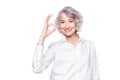 Portrait of a mature attractive woman wearing elegant shirt standing over isolated white background smiling with happy Royalty Free Stock Photo