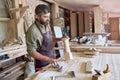 Bearded Carpenter Making Stair Posts in Shop Royalty Free Stock Photo