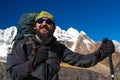Portrait of mature bearded smiling alpine Climber in Mountains