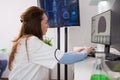 Portrait of mature biologist woman working on computer