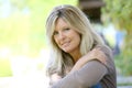 Portrait of mature blond woman sitting outdoors Royalty Free Stock Photo