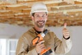 portrait mature builder with thumbs-up holding cordless drill Royalty Free Stock Photo