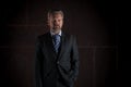 Portrait of a mature businessman on black background