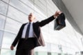 Portrait of mature businessman calling taxi in the airport Royalty Free Stock Photo