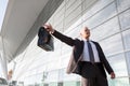 Portrait of mature businessman calling taxi in the airport Royalty Free Stock Photo