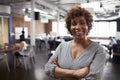 Portrait Of Mature Businesswoman In Modern Open Plan Office