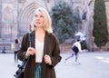 Portrait of mature cheerful woman standing on a old city street Royalty Free Stock Photo