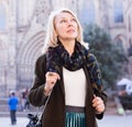 Portrait of mature cheerful woman standing on a old city street Royalty Free Stock Photo