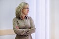 Portrait of mature confident business woman with crossed arms in office