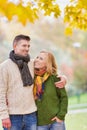 Portrait of Mature couple enjoying autumn while walking in park