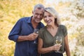 Portrait of mature couple having glasses of wine in balcony