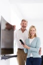 Portrait Of Mature Couple With New Curved Screen Television At H Royalty Free Stock Photo