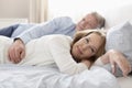 Portrait of mature couple relaxing on bed at home Royalty Free Stock Photo