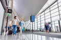 Portrait of mature couple walking while talking in airport