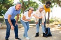 Portrait of mature couples playing petanque at leisure