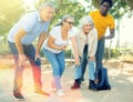 Portrait of mature couples playing petanque at leisure