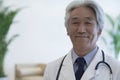 Portrait of mature doctor looking at camera and smiling Royalty Free Stock Photo