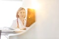 Portrait of mature doctor looking at patient medical result on her computer in clinic Royalty Free Stock Photo