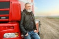 Portrait of mature driver at modern truck outdoors