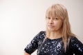 a woman in a dark blue shiny dress close-up looks into the frame she has a tired face without makeup and sad eyes Royalty Free Stock Photo