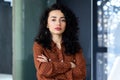 Portrait of mature female boss inside office building, successful hispanic woman looking serious at camera with crossed Royalty Free Stock Photo