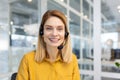 Portrait of mature female customer service worker, mature business woman with video call headset smiling and looking at Royalty Free Stock Photo